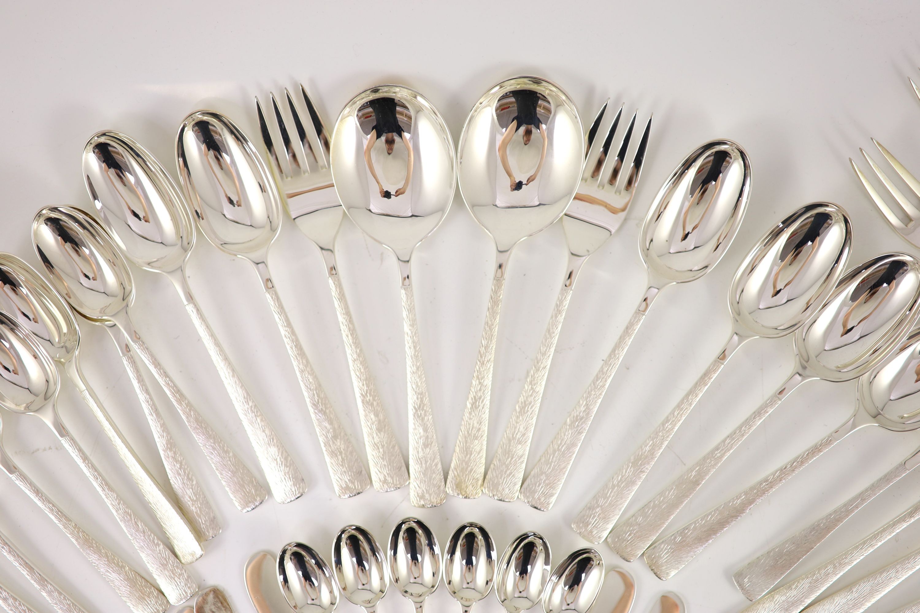 A good part textured silver canteen of cutlery for six by Adrian Gerald Benney